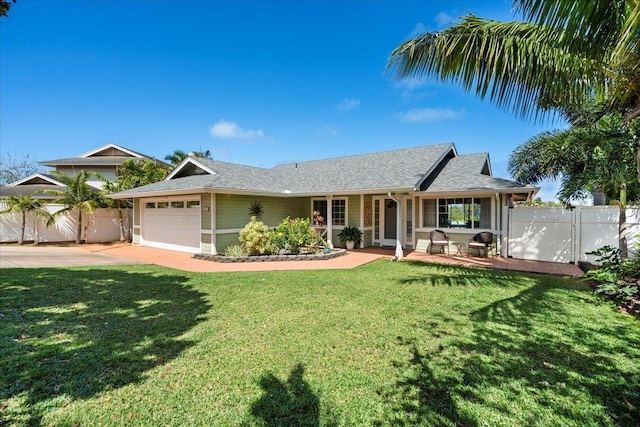 ranch-style house featuring an attached garage, fence, concrete driveway, a front lawn, and a gate