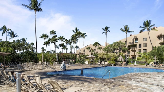 pool featuring fence and a patio area