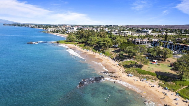 drone / aerial view featuring a beach view and a water view