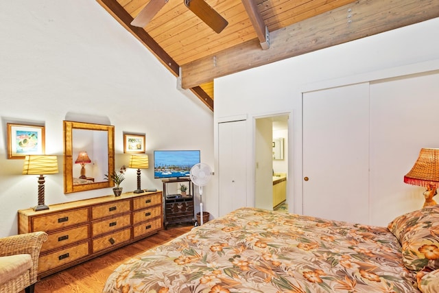 bedroom with wood ceiling, lofted ceiling with beams, wood finished floors, two closets, and ceiling fan