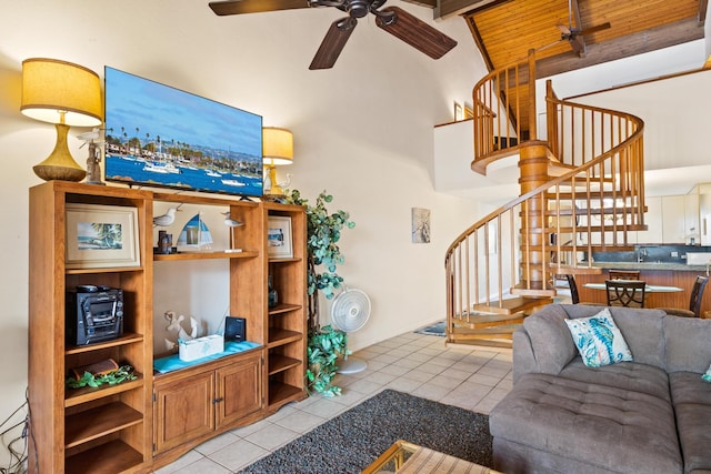 tiled living room featuring wood ceiling, beam ceiling, ceiling fan, and high vaulted ceiling