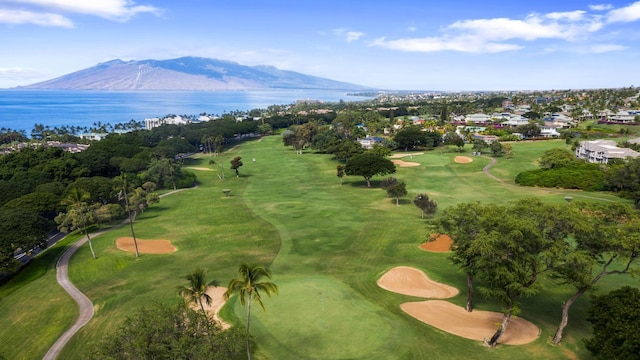 aerial view with view of golf course and a water and mountain view