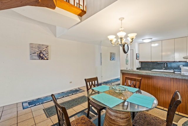 dining room with baseboards, light tile patterned floors, and an inviting chandelier
