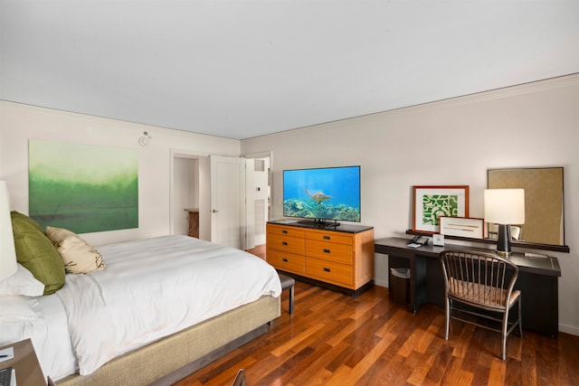 bedroom with ornamental molding and dark hardwood / wood-style flooring