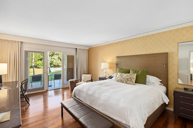 bedroom with dark hardwood / wood-style flooring, access to exterior, and ornamental molding