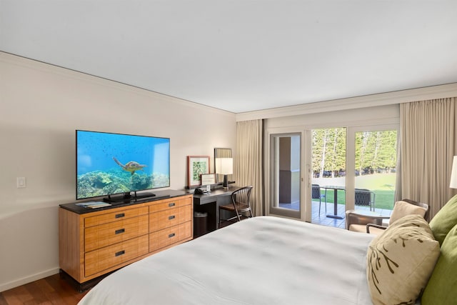 bedroom featuring dark hardwood / wood-style floors, crown molding, and access to outside