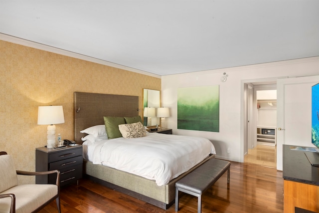 bedroom with crown molding and dark hardwood / wood-style floors