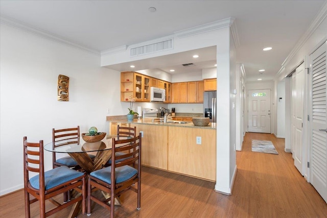 kitchen with stainless steel fridge with ice dispenser, electric range oven, ornamental molding, dark hardwood / wood-style flooring, and kitchen peninsula