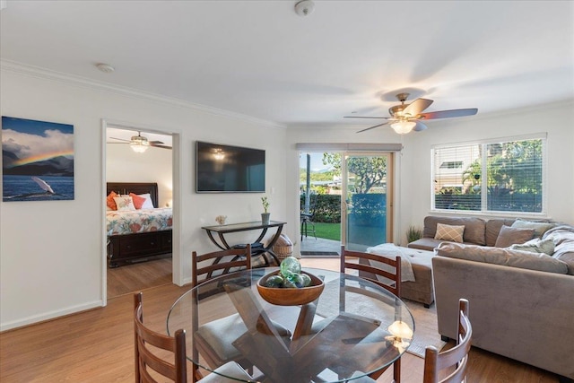 living room featuring ceiling fan, ornamental molding, and light hardwood / wood-style floors