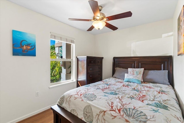 bedroom with hardwood / wood-style floors and ceiling fan