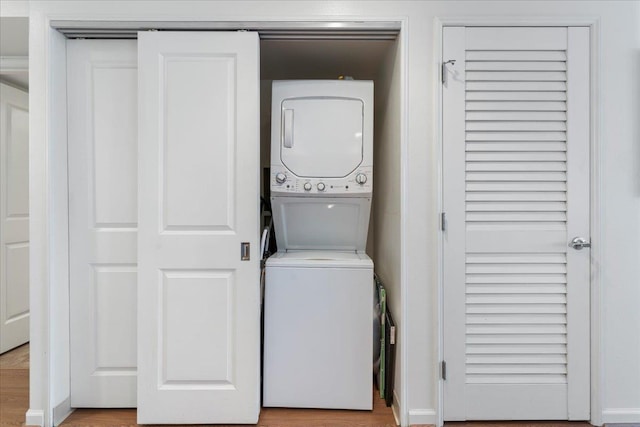 clothes washing area with stacked washer / drying machine