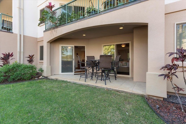 exterior space featuring a patio, a balcony, and a yard