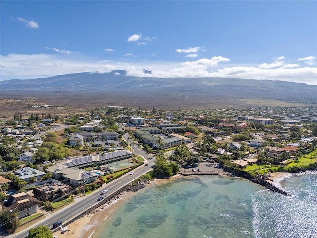 drone / aerial view with a view of the beach and a water and mountain view