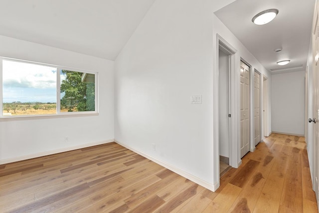 495 Kaiolohia St, Kihei, HI 96753 - unfurnished room with baseboards, vaulted ceiling, and light wood-style floors