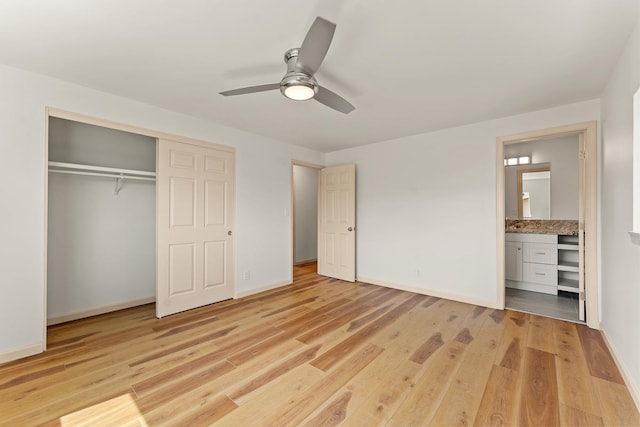 495 Kaiolohia St, Kihei, HI 96753 - unfurnished bedroom with connected bathroom, light wood-style flooring, ceiling fan, baseboards, and a closet