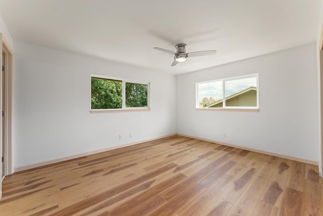 495 Kaiolohia St, Kihei, HI 96753 - empty room featuring a wealth of natural light, a ceiling fan, light wood finished floors, and baseboards
