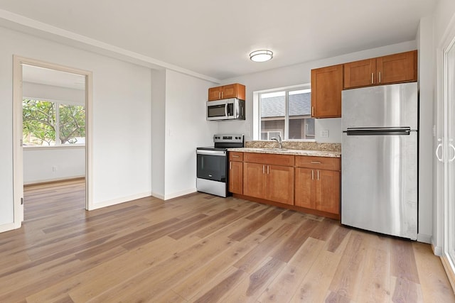 495 Kaiolohia St, Kihei, HI 96753 - kitchen featuring baseboards, brown cabinetry, appliances with stainless steel finishes, and light wood finished floors