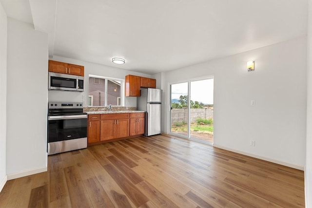 495 Kaiolohia St, Kihei, HI 96753 - kitchen with baseboards, light wood-style floors, appliances with stainless steel finishes, and a sink