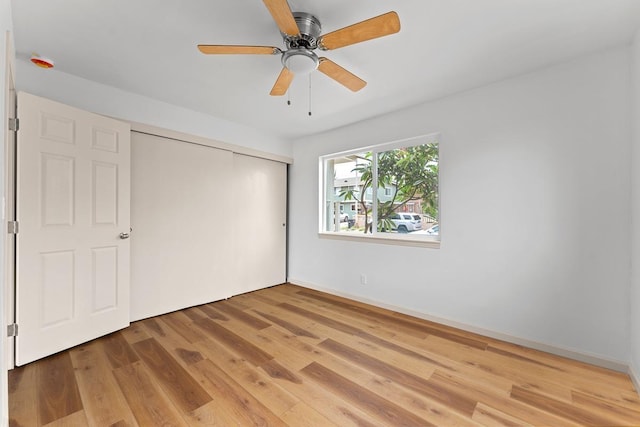 495 Kaiolohia St, Kihei, HI 96753 - unfurnished bedroom with a closet, ceiling fan, and light wood-type flooring