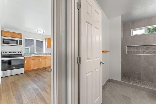 495 Kaiolohia St, Kihei, HI 96753 - full bath with baseboards, a walk in shower, and vanity