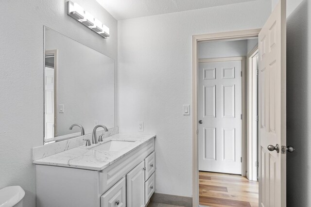 495 Kaiolohia St, Kihei, HI 96753 - bathroom featuring baseboards, wood finished floors, toilet, and vanity