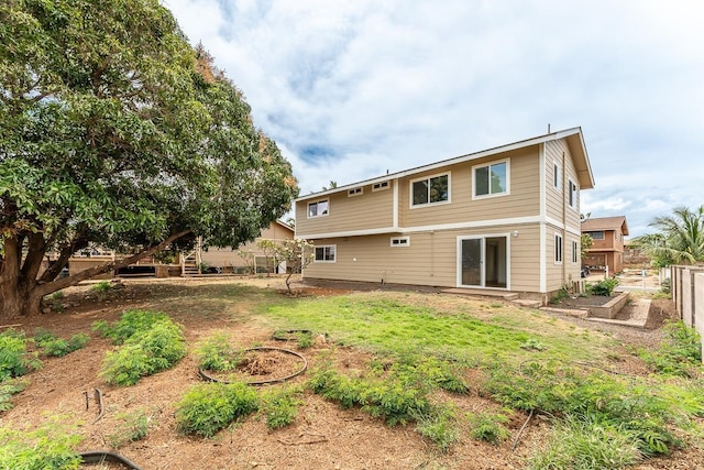 495 Kaiolohia St, Kihei, HI 96753 - back of house featuring fence and a vegetable garden