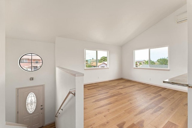495 Kaiolohia St, Kihei, HI 96753 - foyer featuring a wall mounted air conditioner, high vaulted ceiling, light wood-style flooring, and baseboards