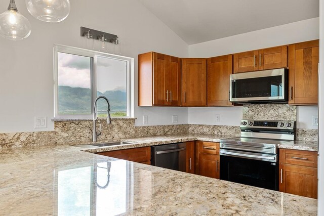495 Kaiolohia St, Kihei, HI 96753 - kitchen with light stone counters, brown cabinets, a sink, appliances with stainless steel finishes, and vaulted ceiling