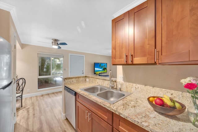 kitchen with crown molding, light stone countertops, dishwasher, sink, and light wood-type flooring