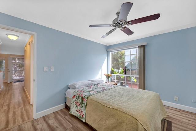 bedroom featuring light wood-type flooring, ceiling fan, and crown molding