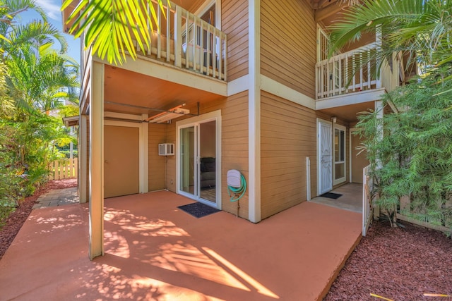 view of patio featuring a balcony and a wall mounted air conditioner