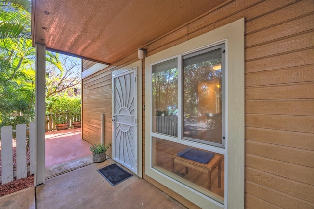 view of exterior entry featuring a patio