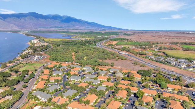 aerial view featuring a water and mountain view