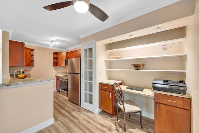 kitchen with stainless steel appliances, light stone countertops, ornamental molding, light hardwood / wood-style floors, and built in desk