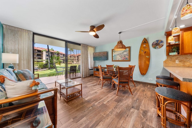 interior space featuring hardwood / wood-style flooring, floor to ceiling windows, and ceiling fan