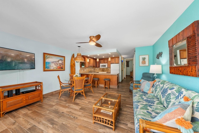 living room featuring ceiling fan and wood-type flooring