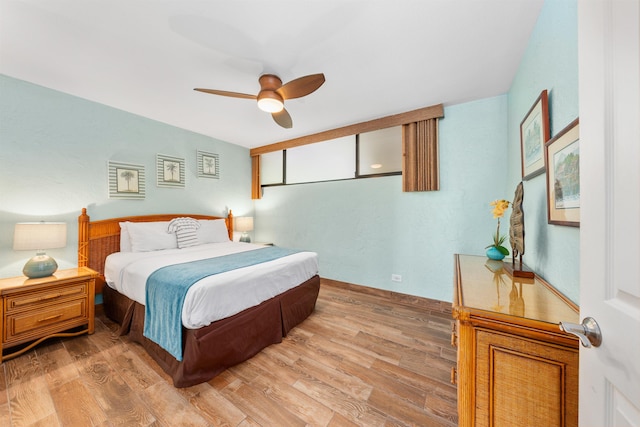 bedroom with wood-type flooring and ceiling fan