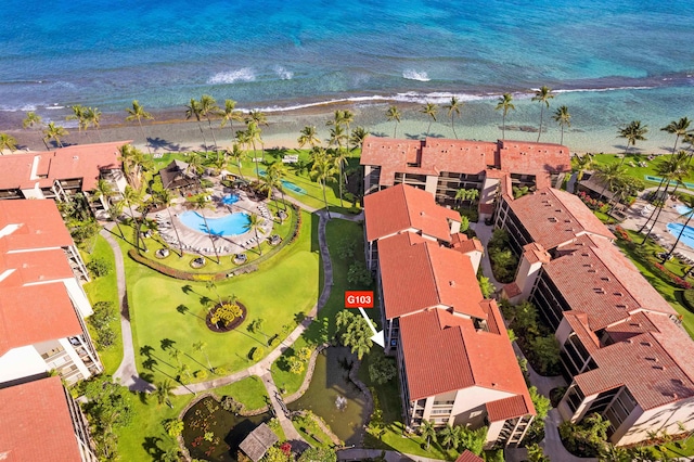 birds eye view of property featuring a water view and a beach view