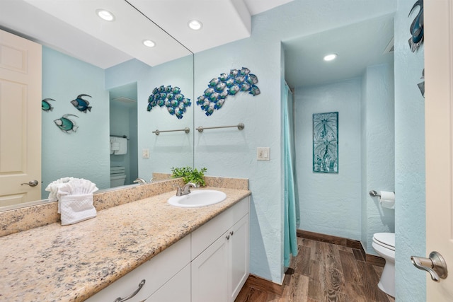 bathroom featuring hardwood / wood-style floors, toilet, and vanity