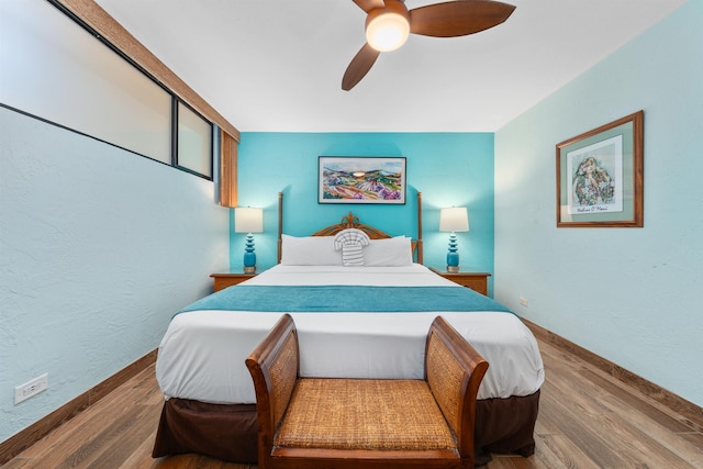 bedroom with ceiling fan, hardwood / wood-style flooring, and a closet