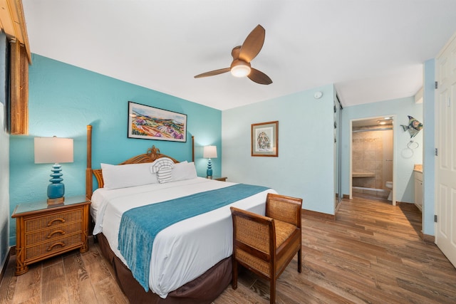 bedroom with ceiling fan, wood-type flooring, and ensuite bath