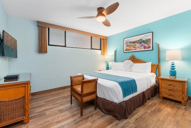 bedroom with ceiling fan and hardwood / wood-style floors