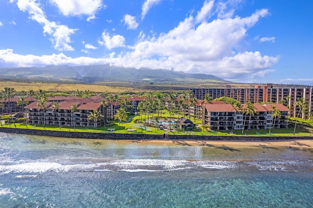 birds eye view of property with a water and mountain view