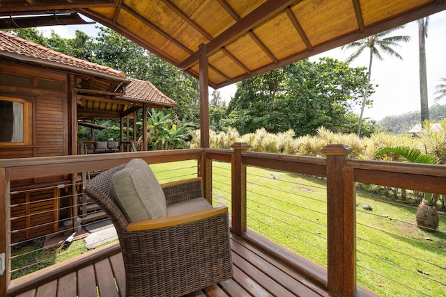 wooden terrace with a lawn