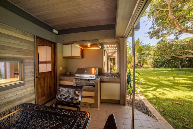 view of patio / terrace with a grill, exterior kitchen, and sink