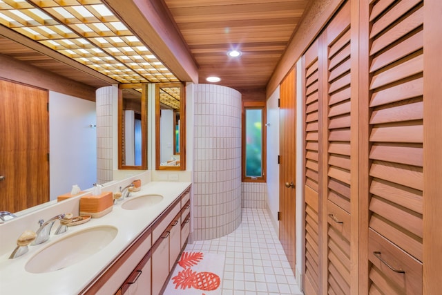 bathroom featuring tile patterned flooring, vanity, and wooden ceiling