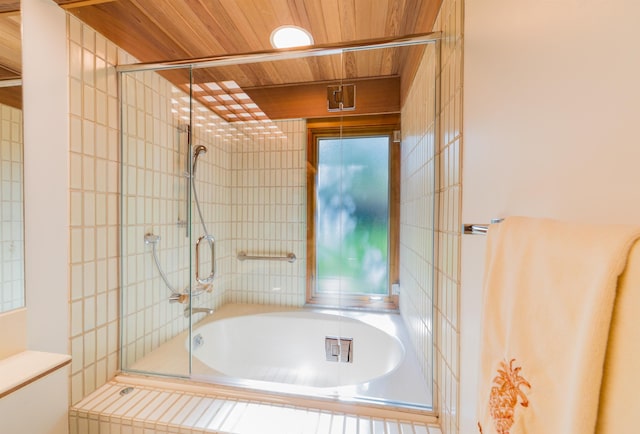 bathroom with wooden ceiling and shower / bath combination with glass door