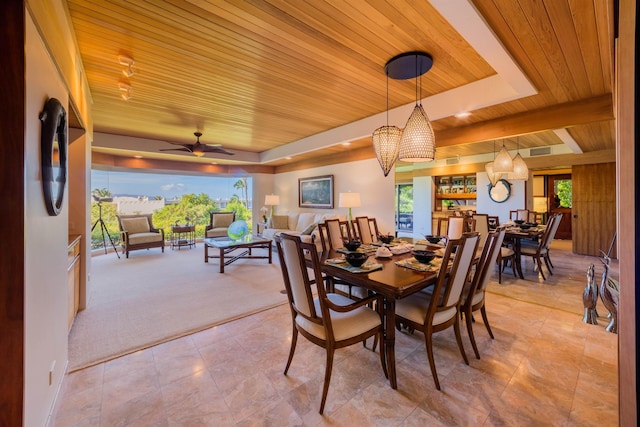 dining room featuring wood ceiling, ceiling fan, and carpet floors