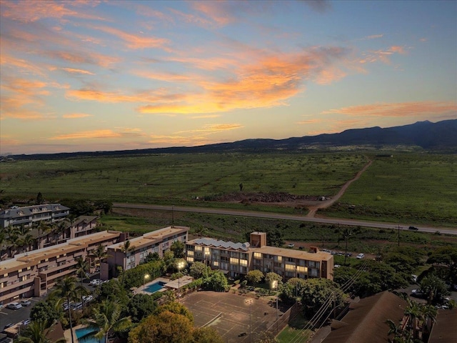 aerial view at dusk featuring a mountain view