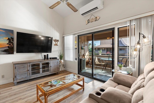 living room with an AC wall unit, ceiling fan, and light wood-type flooring